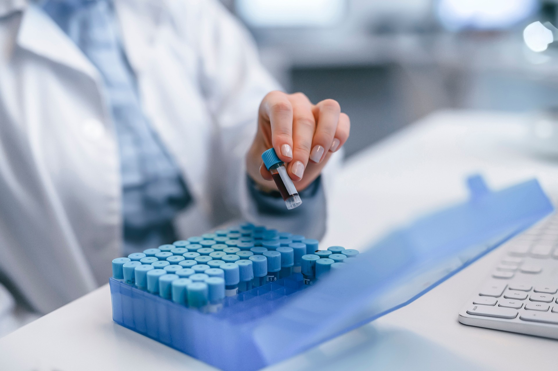 Doctor, scientist or medical professional organizing, sorting and packing DNA or RNA in storage. Innovation from researcher experimenting for a future vaccine with samples at a science factory